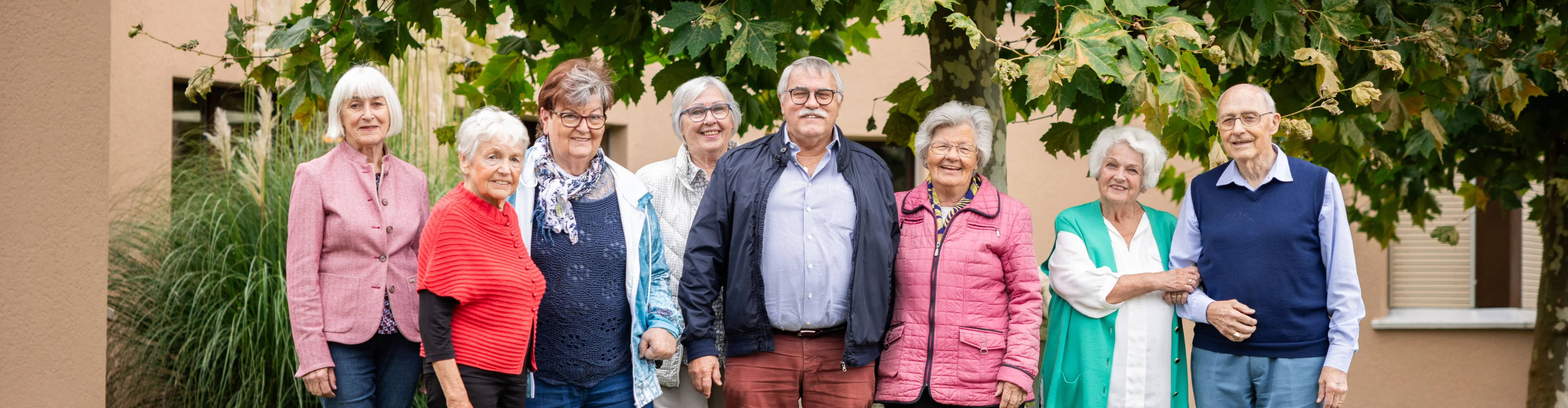 8 elderly people standing together